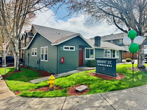 A house with a sign that says Bryant St. Townhomes.